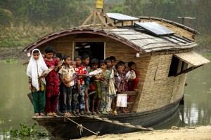 Students of class one on the boat school, pose for a photograph, after the end of their classes. The floating boat school moves from one area to another and goes to the children for giving education as the children don't go to the traditional school because of lack of communication during flooding, Billdohor, Natore.Billdohor, Natore.